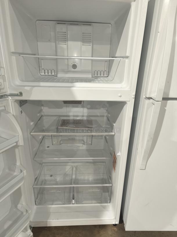 Whirlpool 30-inch top-freezer refrigerator, model WRT318FZDW11, 18 cu ft. Clean, spacious interior with adjustable shelves.