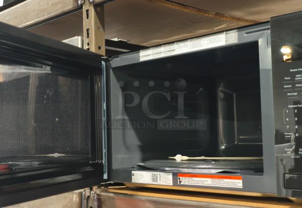 BRAND NEW GE Profile 2.2 cu ft Built-In Sensor Microwave, Model PCWK22U1WDD, open door, minor scratches, tags and labels visible.