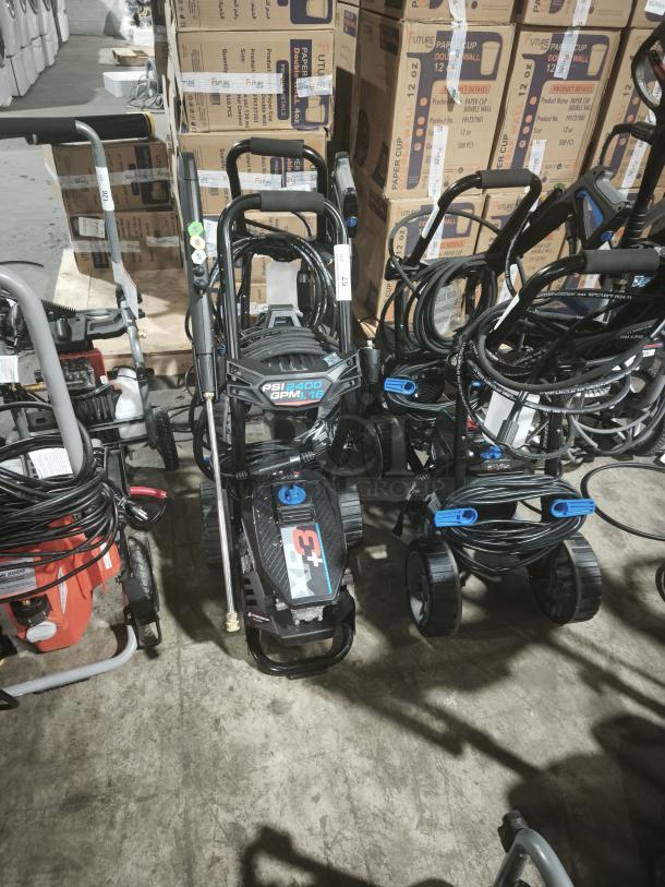 AR Blue Clean XP3-2400 electric pressure washer, tested and working. Features 2400 PSI, sturdy wheels, and hose reel.