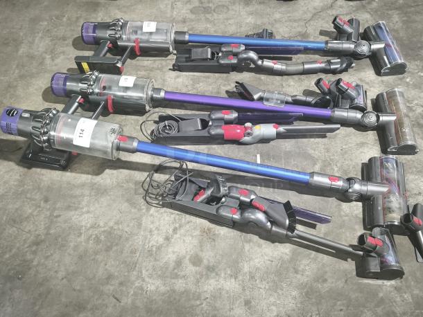Dyson V11 Torque Drive PLUS cordless stick vacuums, three units, tested and working, with charging bases and attachments.