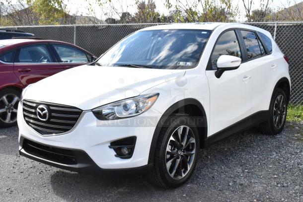 2016 Mazda CX-5 Grand Touring 4WD in white. Excellent condition, includes key. VIN: JM3KE4DY0G0778964.