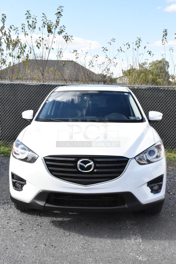 2016 Mazda CX-5 Grand Touring 4WD in white, front view. Includes key. VIN: JM3KE4DY0G0778964.