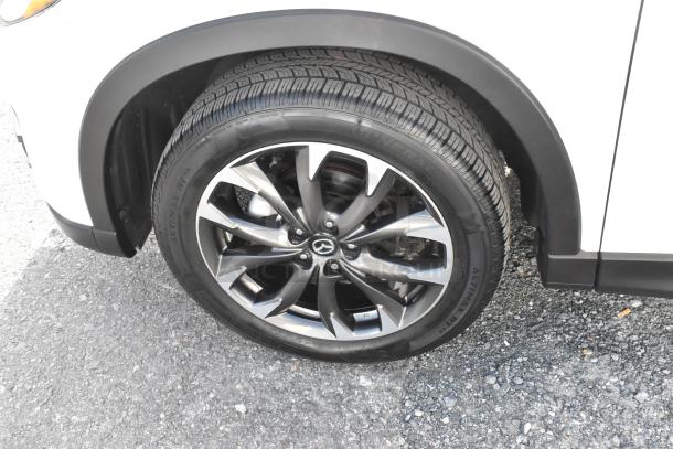 2016 Mazda CX-5 Grand Touring 4WD SUV in white, showcasing a detailed view of the wheel and tire.