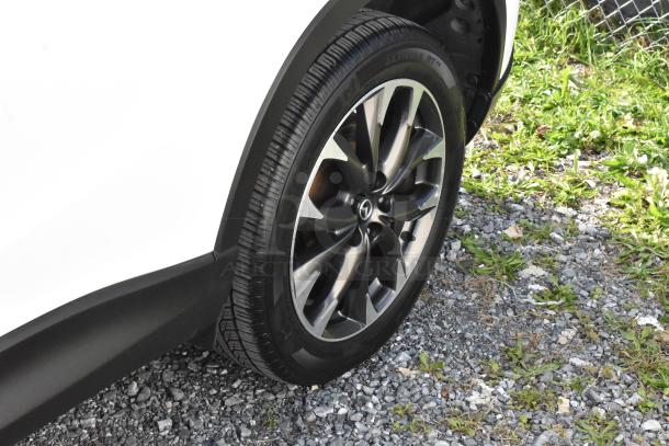 Close-up of a 2016 Mazda CX-5 Grand Touring 4WD, showing a detailed view of the alloy wheel and tire in excellent condition.