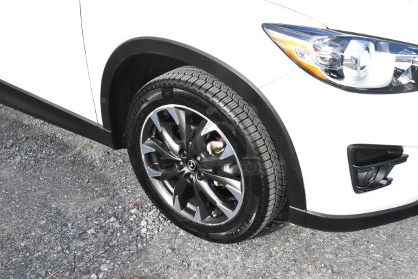 2016 Mazda CX-5 Grand Touring 4WD SUV in white, showing front right tire and headlight, in excellent condition.