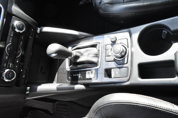 2016 Mazda CX-5 Grand Touring 4WD interior console, featuring gear shifter, controls, and clean condition.