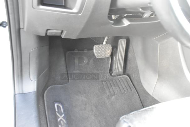 2016 Mazda CX-5 Grand Touring 4WD interior view, showing floor mat with CX-5 logo, brake, and accelerator pedals.