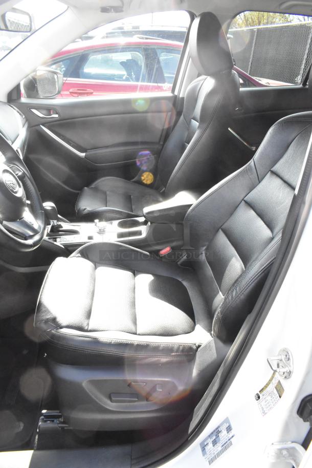 2016 Mazda CX-5 Grand Touring 4WD interior, black leather seats, excellent condition, white exterior, visible VIN label.