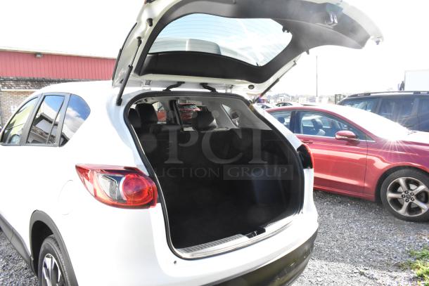 2016 Mazda CX-5 Grand Touring 4WD in white, rear view with open trunk. VIN JM3KE4DY0G0778964. Includes key.