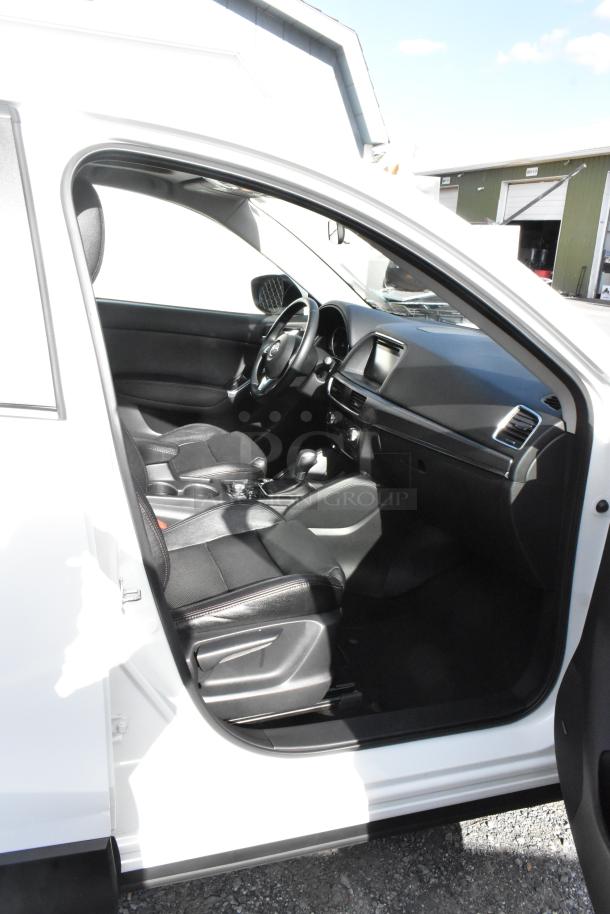2016 Mazda CX-5 Grand Touring 4WD, white exterior, black interior. VIN JM3KE4DY0G0778964. Includes key. Appears in good condition.