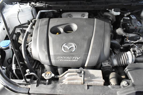 2016 Mazda CX-5 engine with Skyactiv Technology logo, showcasing key mechanical components. Clean condition.