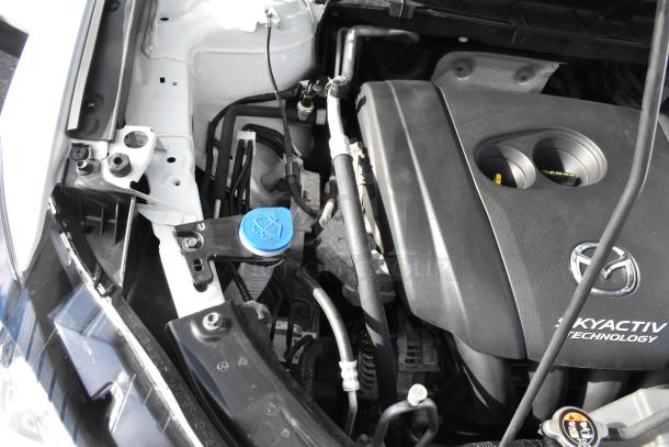 Engine bay of a 2016 Mazda CX-5 Grand Touring 4WD, showcasing Skyactiv Technology engine components. Clean condition.