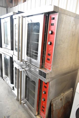 Migali stainless steel commercial convection ovens with view-through doors, metal racks, red thermostatic controls, and casters.