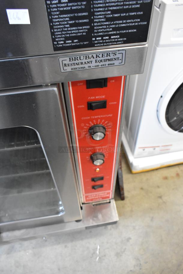 Migali stainless steel convection oven with view-through doors, metal racks, thermostatic controls, and commercial casters.