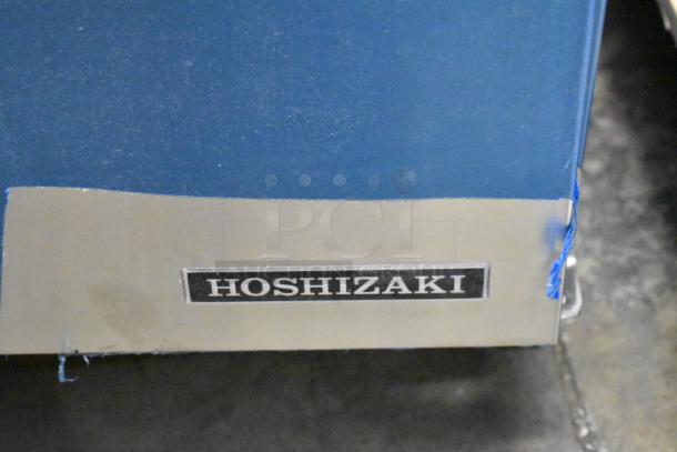 Brand new Hoshizaki AM-50BAK stainless steel ice machine, undercounter model, with 27 lb bin capacity. Marked "Hoshizaki."