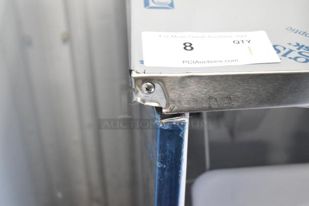 Stainless steel Hoshizaki AM-50BAK ice machine with scratch and dent damage on corner, auction tag visible.