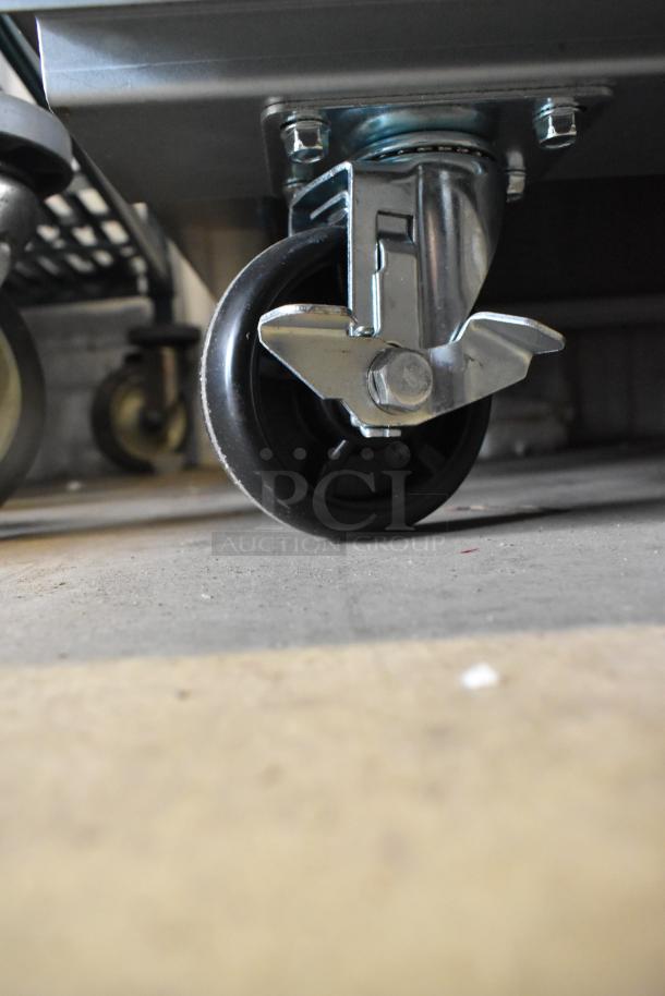 Close-up of a caster wheel on a 2025 Avantco 178SS3FHC stainless steel 3-door reach-in cooler, showcasing mobility feature.