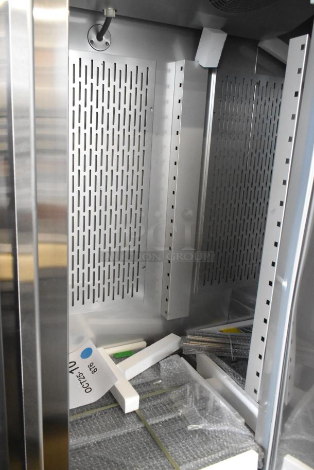 Brand new Avantco 178SS3FHC stainless steel 3-door cooler interior, with poly coated racks and commercial casters.