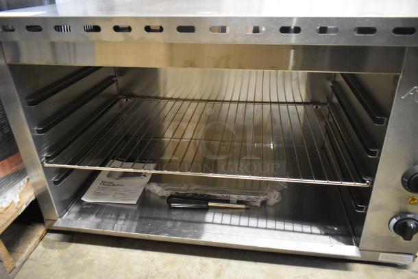 Brand new Avantco 177CHSME32IM stainless steel 32" electric cheese melter, 208/240V, 1 phase, with manual and accessories.