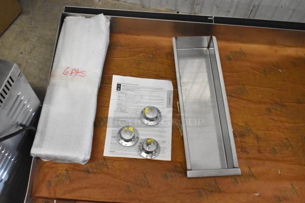Brand new 2025 Imperial ITG-72 stainless steel flat top griddle package, showing griddle components and instructions.