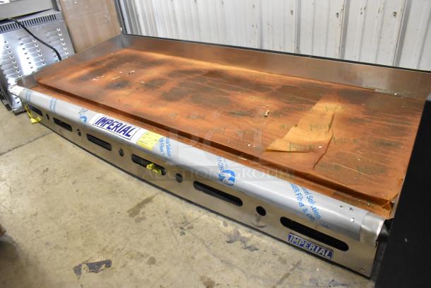 BRAND NEW 2025 Imperial ITG-72 stainless steel flat top griddle, natural gas, scratch and dent condition, protective covering visible.