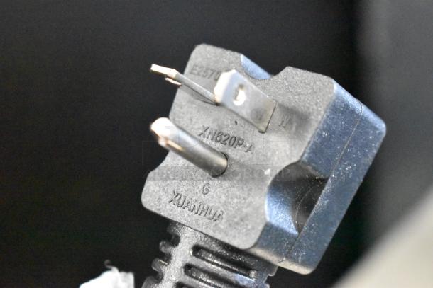 Close-up view of a plug on the Carnival King 382TCM16DBL crepe maker, featuring a three-prong design with visible markings.