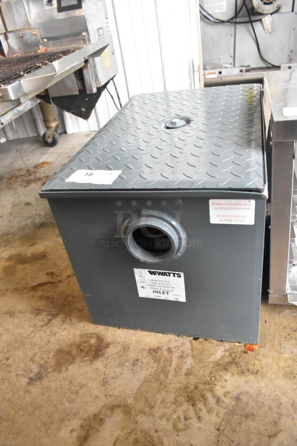 BRAND NEW Watts WD-25-THD 50 lb. grease trap with threaded connections, minor scratches and dents, labeled inlet and model info.