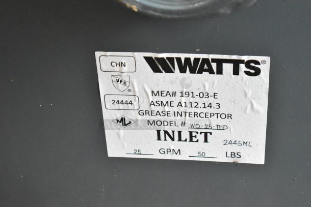 Brand new Watts WD-25-THD grease trap, 50 lb capacity, threaded connections. ASME and UPC certified. Model label visible.