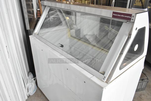 Kelvinator metal commercial ice cream dipping cabinet with glass side panel cracks, 115 volts, 1 phase, in used condition.