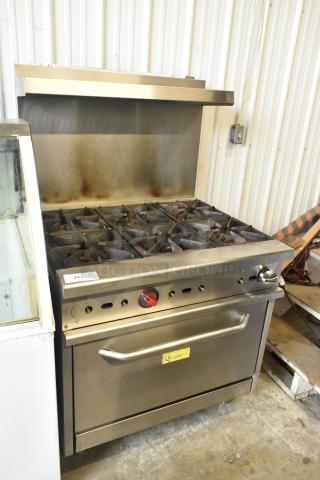 Qualite stainless steel 6-burner commercial gas range with oven, overhead shelf, and backsplash. Good condition.