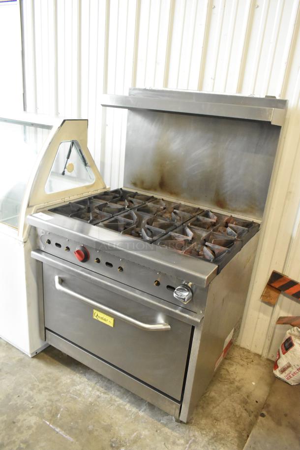Qualite stainless steel 6-burner commercial gas range with oven, over shelf, and backsplash; good condition.