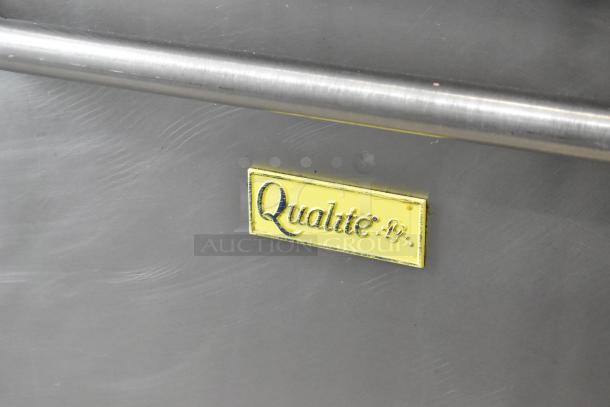 Qualite stainless steel gas 6-burner range with oven, overshelf, and backsplash. Qualite logo visible.