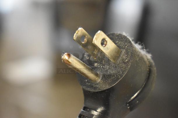 Close-up of a dusty electrical plug for True GDM-12-HC commercial cooler, model 2018, 115V, 1 phase.