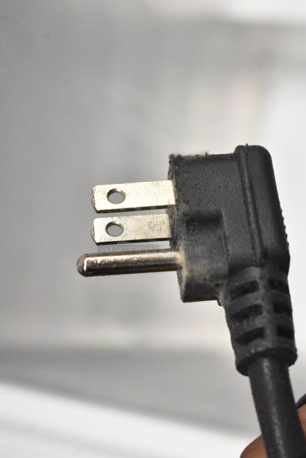 Close-up image of a power plug for Hisense WFC050M6XWD chest freezer, 115V, 1 Phase. Dust visible on the plug.