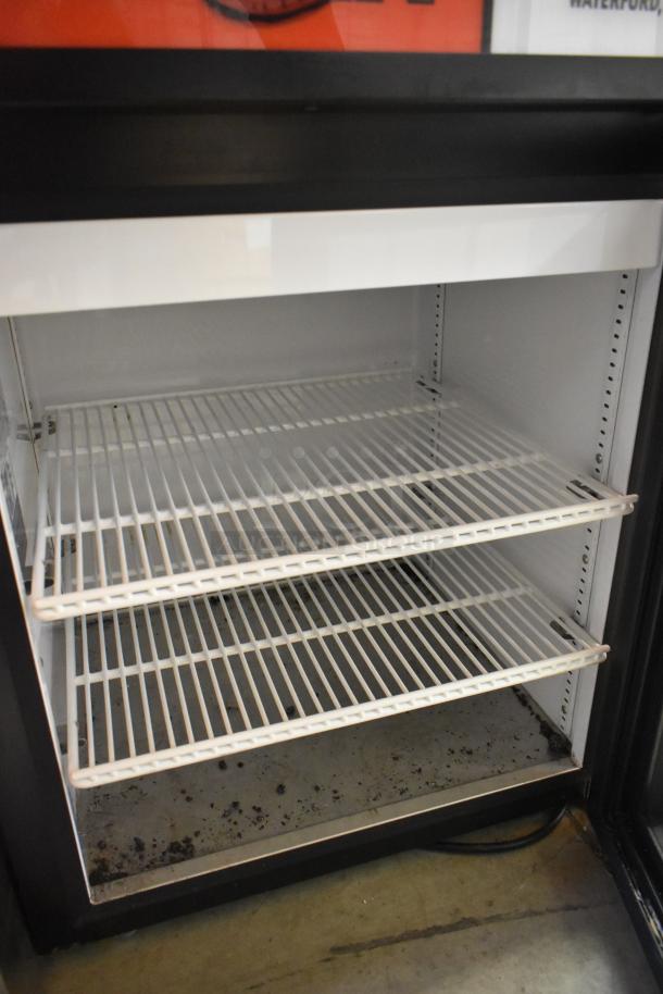 2024 True GDM-05-HC Metal Mini Cooler Merchandiser with white wire shelving. 115 Volts, 1 Phase. Visible wear inside.