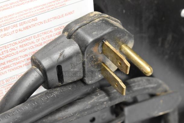 Close-up of the power plug for a 2018 Menumaster MRC30S2 stainless steel commercial countertop microwave, 208/240 volts, 1 phase.