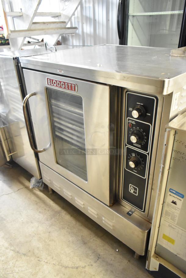 Blodgett gas convection oven, stainless steel, half size, view-through door, metal racks, thermostatic controls, good condition.