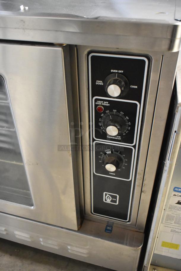 Blodgett stainless steel gas convection oven with view-through door, metal racks, and thermostatic controls, in good condition.