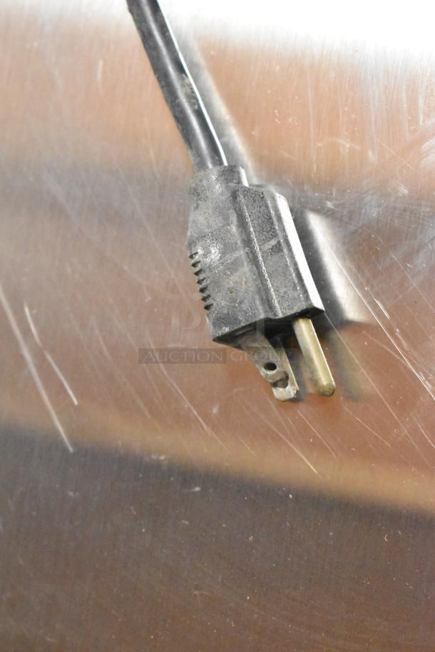 Blodgett stainless steel convection oven plug, scruffed, attached to oven with a view-through door and metal racks.