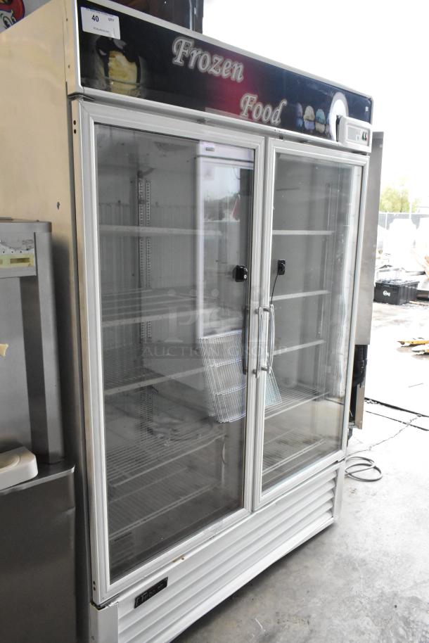 Turbo Air TGF-49F commercial metal freezer, 2 glass doors, poly-coated racks, 115V, 1 phase, "Frozen Food" sign on top.