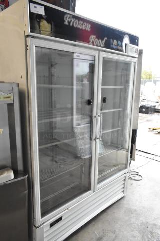 Turbo Air TGF-49F commercial metal freezer, 2 glass doors, poly-coated racks, 115V, 1 phase, "Frozen Food" sign on top.