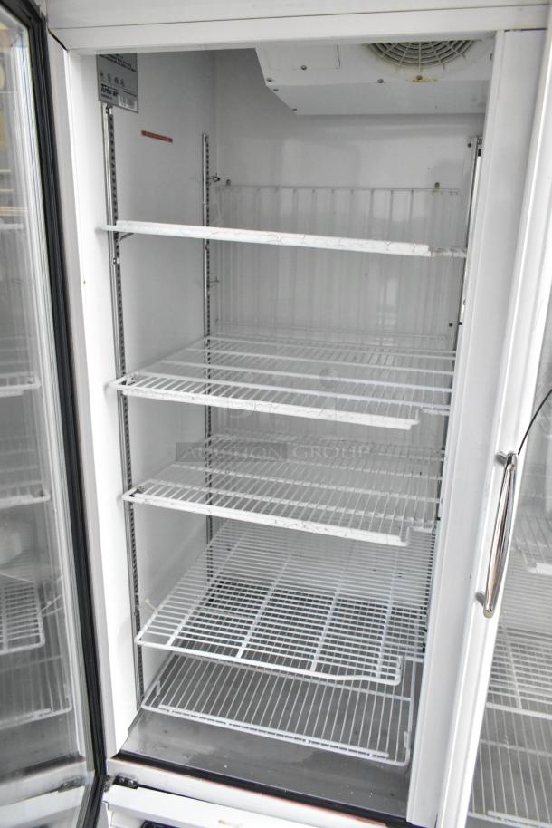 Turbo Air TGF-49F commercial freezer with two doors, metal body, and poly coated racks. 115 volts, 1 phase. Excellent condition.