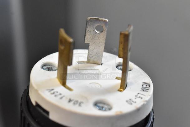 Close-up of a plug for the BQ333 Stainless Steel Commercial Floor Soft Serve Ice Cream Machine, showing NEMA configuration.