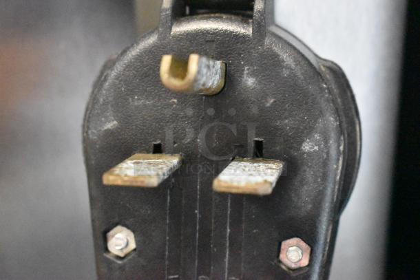 Close-up view of a power plug for the BQ333 Stainless Steel Commercial Ice Cream Machine, 110 Volts, 1 Phase.
