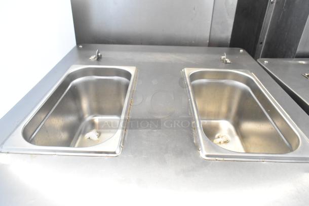 BQ333 stainless steel soft serve machine with dual flavor and twist options, on commercial casters, visible stainless compartments.