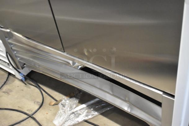 2025 True T-35-HC stainless steel commercial 2-door reach-in cooler, minor dent. Features poly-coated racks, 115V, 1 phase.