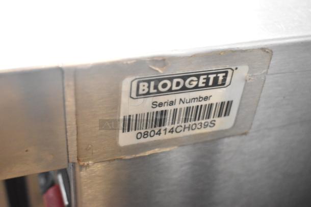 Blodgett stainless steel full-size convection oven, view-through doors, oven racks, thermostatic controls; serial number visible.