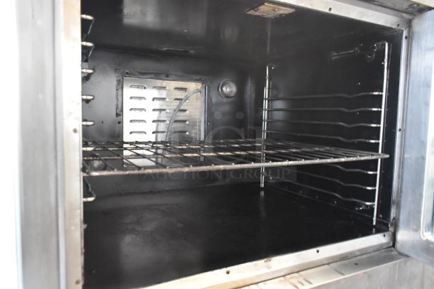 2 stainless steel commercial full-size convection ovens with view-through doors, thermostatic controls, and casters.