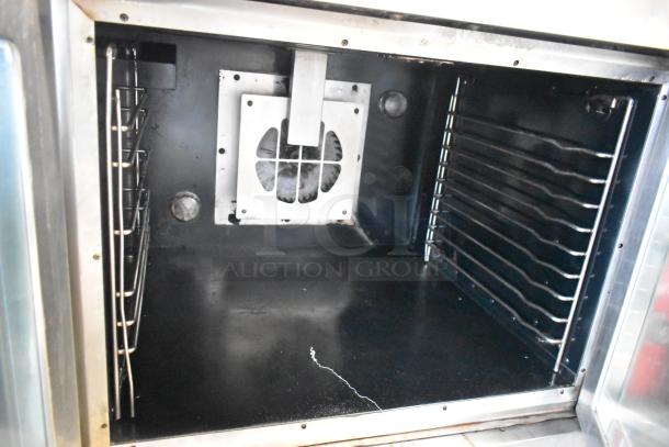 Stainless steel commercial convection oven with view doors, thermostatic controls, on commercial casters. Interior view shown.