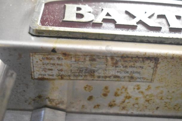 Baxter commercial electric mini rotating rack oven, stainless steel, visible wear, unclear model details on rusty label.
